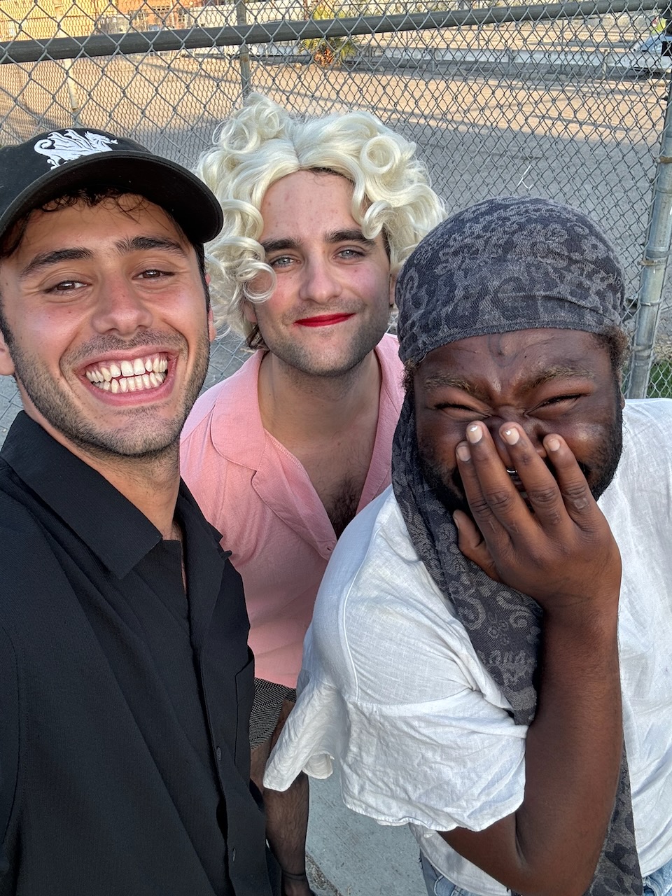 Director with cast members laughing on set